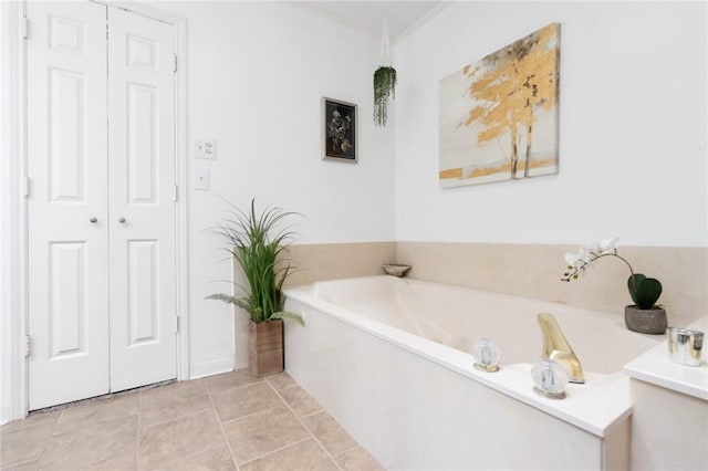 full bathroom featuring a bath, tile patterned flooring, and ornamental molding