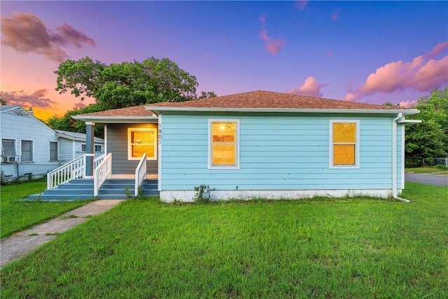 view of front facade with a porch and a lawn