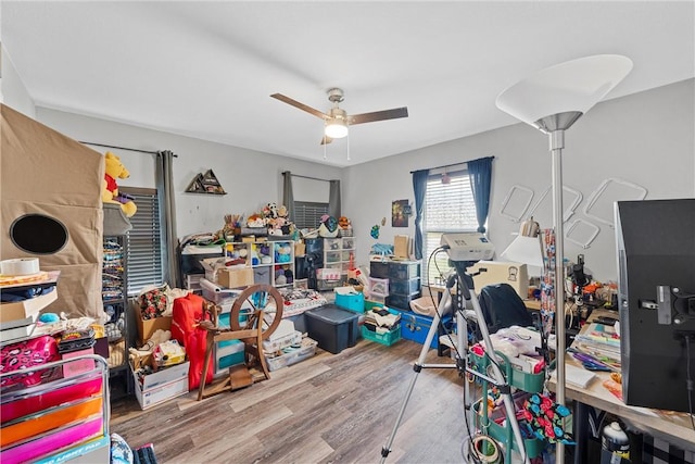 interior space with ceiling fan and wood finished floors