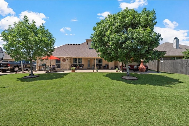 back of property featuring a patio area and a yard