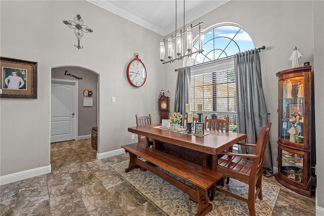 dining area with crown molding and an inviting chandelier