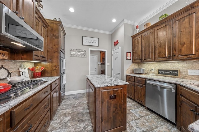 kitchen with a center island, crown molding, light stone countertops, decorative backsplash, and stainless steel appliances