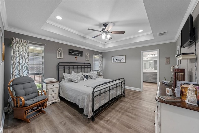 bedroom with crown molding, ceiling fan, and a raised ceiling