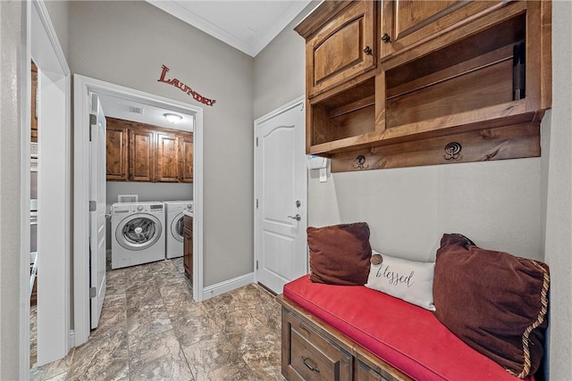 washroom with cabinets, ornamental molding, and independent washer and dryer