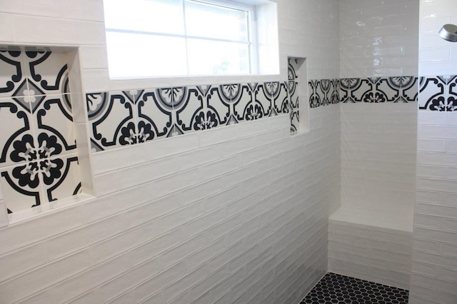 bathroom with tiled shower