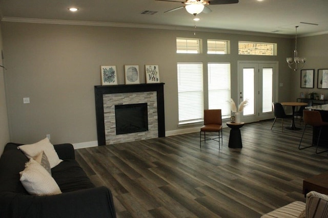 living room with a fireplace, dark wood-type flooring, ceiling fan with notable chandelier, and ornamental molding