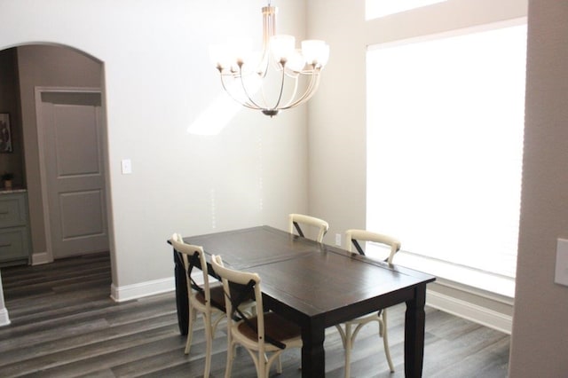 dining room with a notable chandelier and dark hardwood / wood-style floors