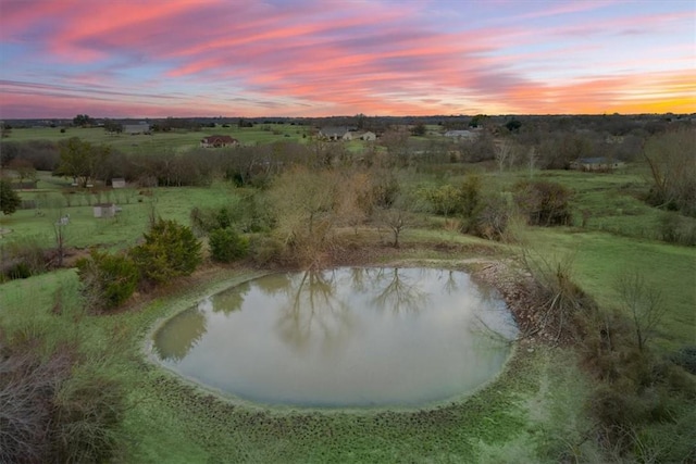 aerial view at dusk with a water view