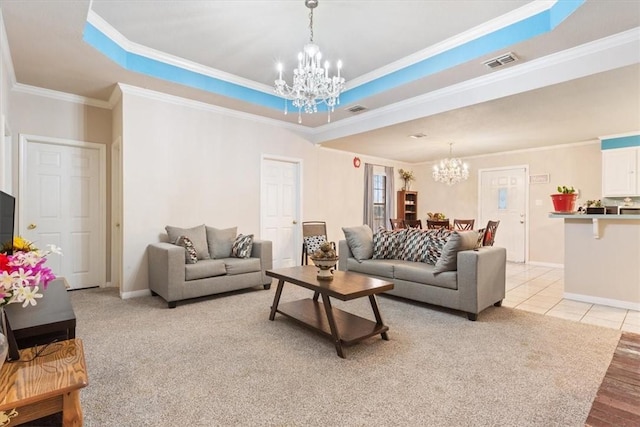 tiled living room featuring a notable chandelier, a tray ceiling, and ornamental molding