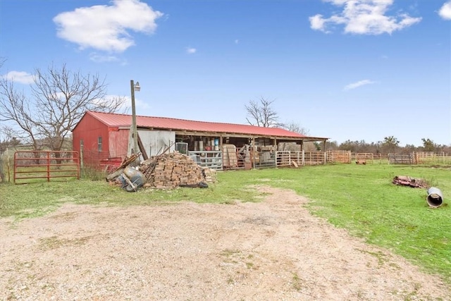 view of front of house with a rural view and an outbuilding