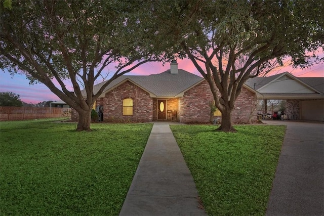 single story home with a carport and a lawn