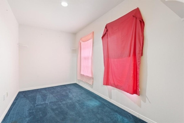 empty room with dark colored carpet