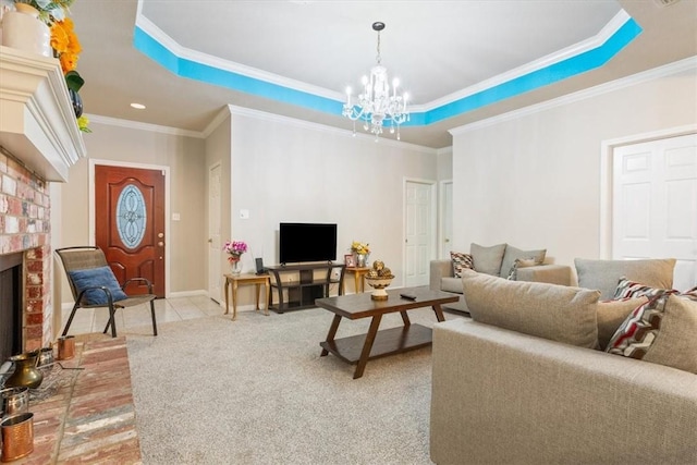 carpeted living room featuring an inviting chandelier, crown molding, a fireplace, and a raised ceiling