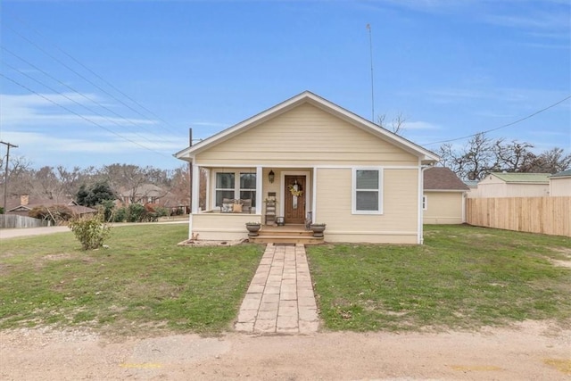 bungalow featuring a porch and a front lawn