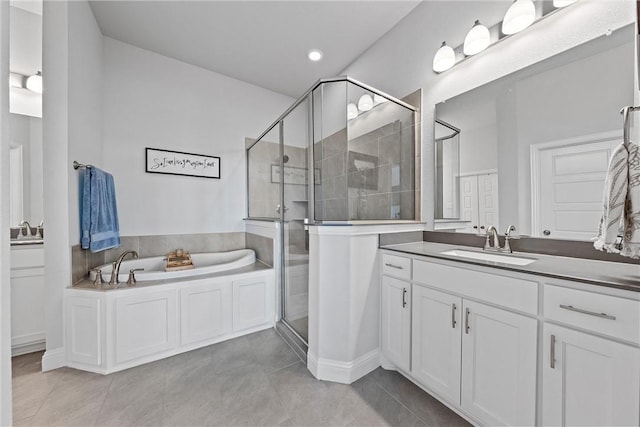 bathroom with plus walk in shower, vanity, and tile patterned floors