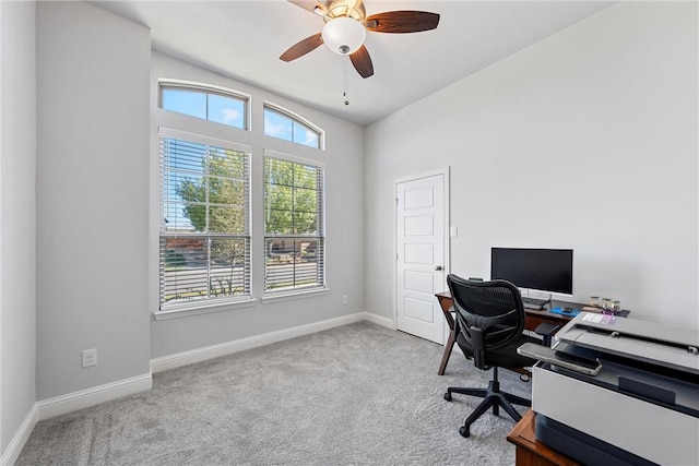 carpeted home office with ceiling fan