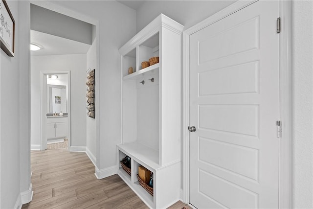 mudroom with light hardwood / wood-style floors