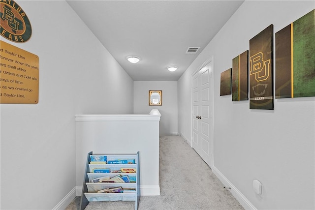 hall featuring light colored carpet