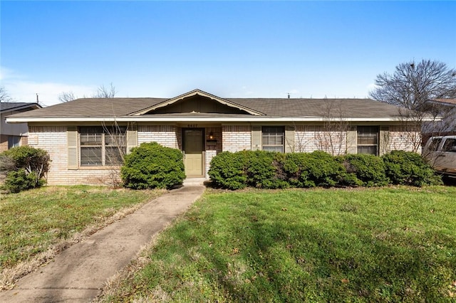 single story home with brick siding and a front yard