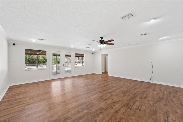 unfurnished living room with ornamental molding, hardwood / wood-style floors, a textured ceiling, and french doors