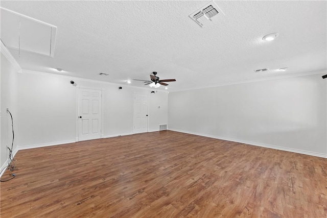 unfurnished room with crown molding, ceiling fan, wood-type flooring, and a textured ceiling