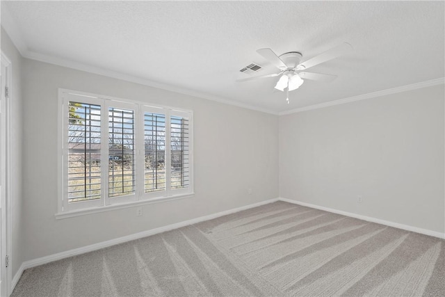 empty room featuring crown molding, ceiling fan, carpet flooring, and a wealth of natural light