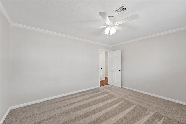 carpeted empty room featuring ornamental molding and ceiling fan