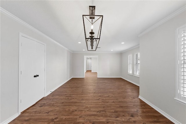 unfurnished living room featuring an inviting chandelier, dark wood-type flooring, and ornamental molding