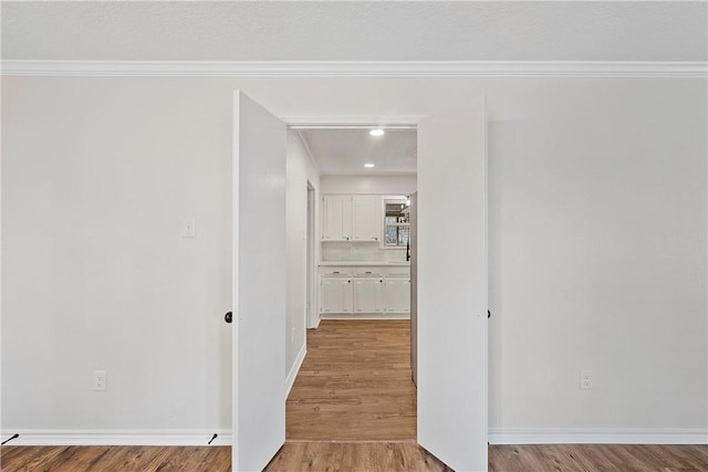 unfurnished living room featuring dark wood-type flooring, crown molding, a tiled fireplace, and a textured ceiling