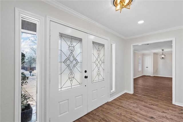 entryway with dark hardwood / wood-style flooring, crown molding, and french doors