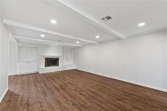 unfurnished living room with beamed ceiling and hardwood / wood-style floors