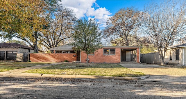 ranch-style home with a front yard and a carport