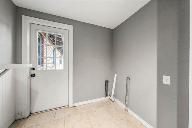 doorway with light tile patterned floors