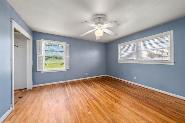 unfurnished bedroom with light wood-type flooring, a closet, and ceiling fan