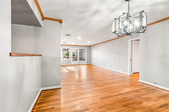 interior space with a notable chandelier, crown molding, and light hardwood / wood-style flooring