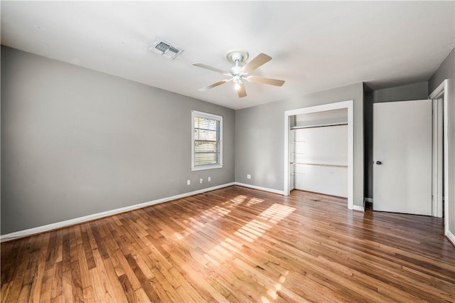 unfurnished bedroom featuring a closet, ceiling fan, and hardwood / wood-style floors