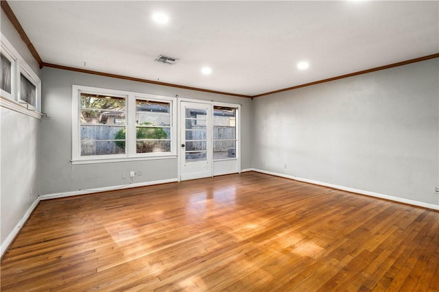 unfurnished room featuring crown molding and light hardwood / wood-style flooring