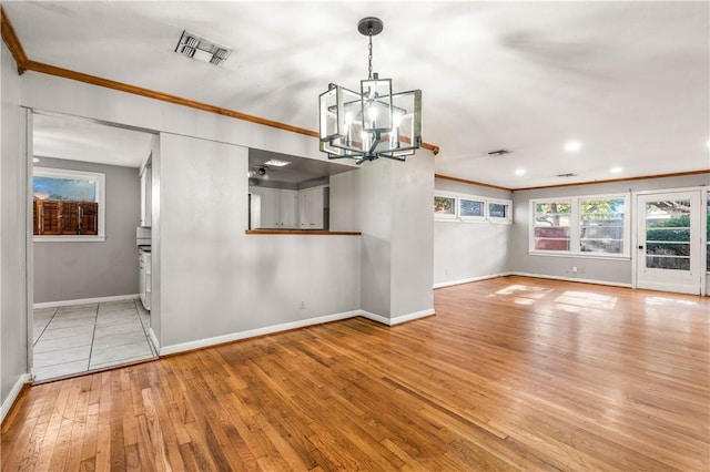 interior space featuring light hardwood / wood-style floors, an inviting chandelier, and ornamental molding