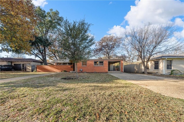 ranch-style home with a front yard and a carport