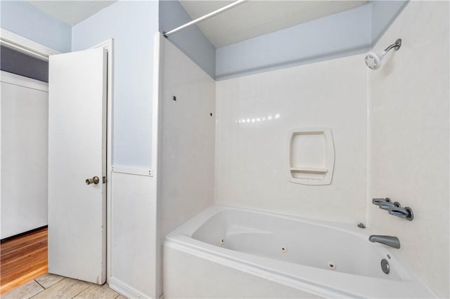 bathroom with wood-type flooring and bathing tub / shower combination