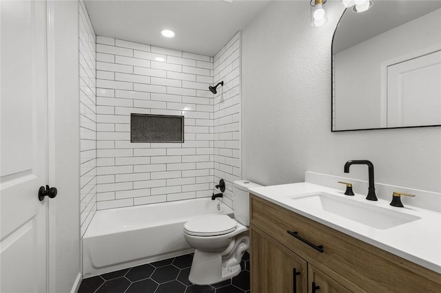 full bathroom with tile patterned flooring, vanity, toilet, and tiled shower / bath