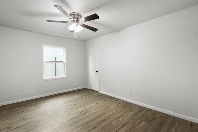 spare room featuring dark hardwood / wood-style flooring and ceiling fan