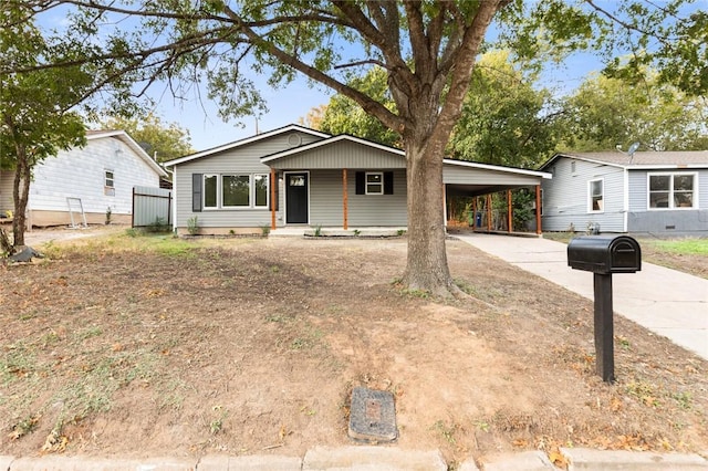 view of front of property featuring a porch and a carport