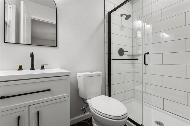 bathroom with vanity, toilet, and an enclosed shower