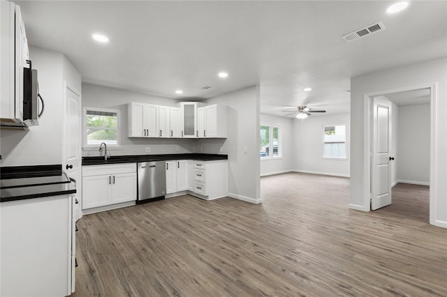 kitchen with ceiling fan, hardwood / wood-style floors, white cabinets, and appliances with stainless steel finishes