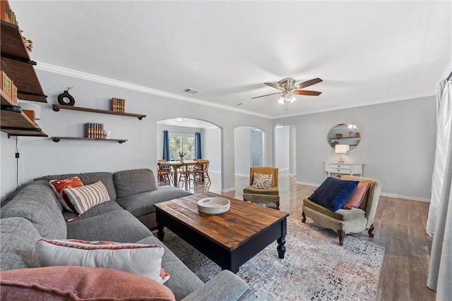 living room with crown molding, hardwood / wood-style floors, and ceiling fan