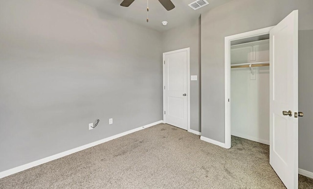 unfurnished bedroom featuring carpet floors, a closet, and ceiling fan