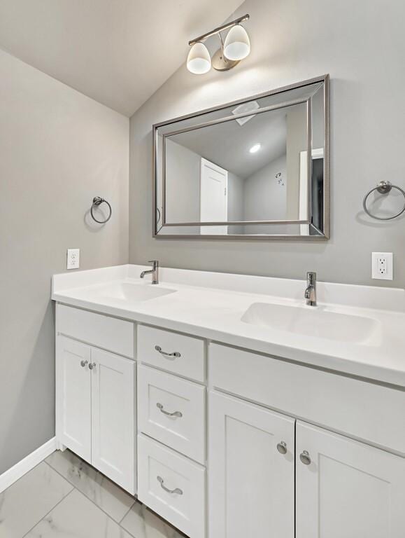 bathroom featuring vanity and vaulted ceiling