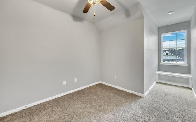 spare room with ceiling fan, carpet floors, and vaulted ceiling