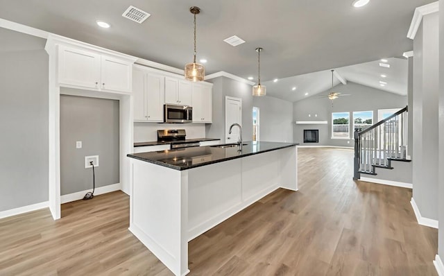 kitchen with ceiling fan, white cabinetry, sink, and appliances with stainless steel finishes